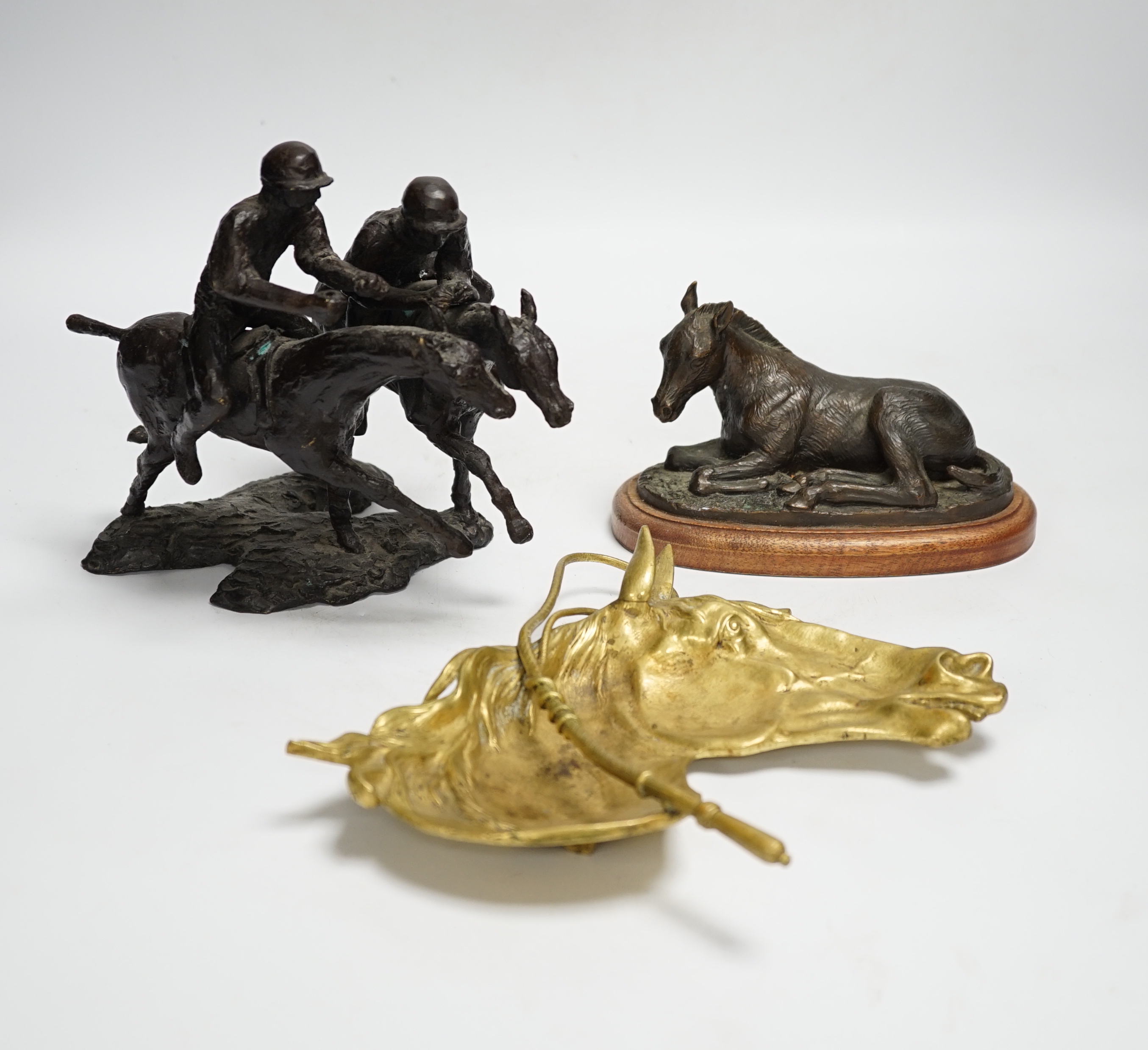 A group of metalware including two jardinieres, two brass dishes, a brass horses, head tray, a bronze of two jockeys on horseback and a bronze of a seated horse, tallest jardiniere 29cm